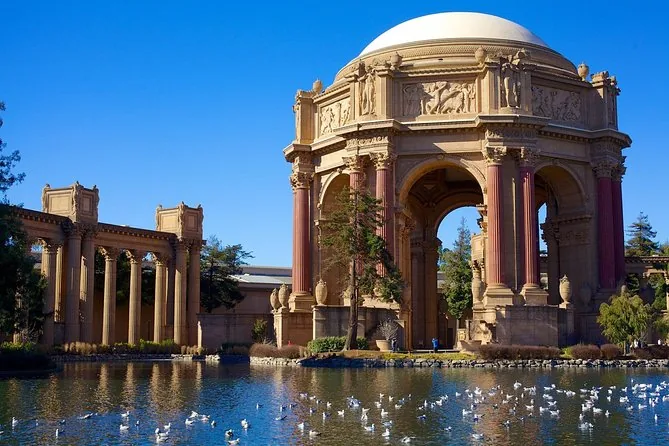 The Palace of Fine Arts rotunda reflected in its lagoon under a blue sky